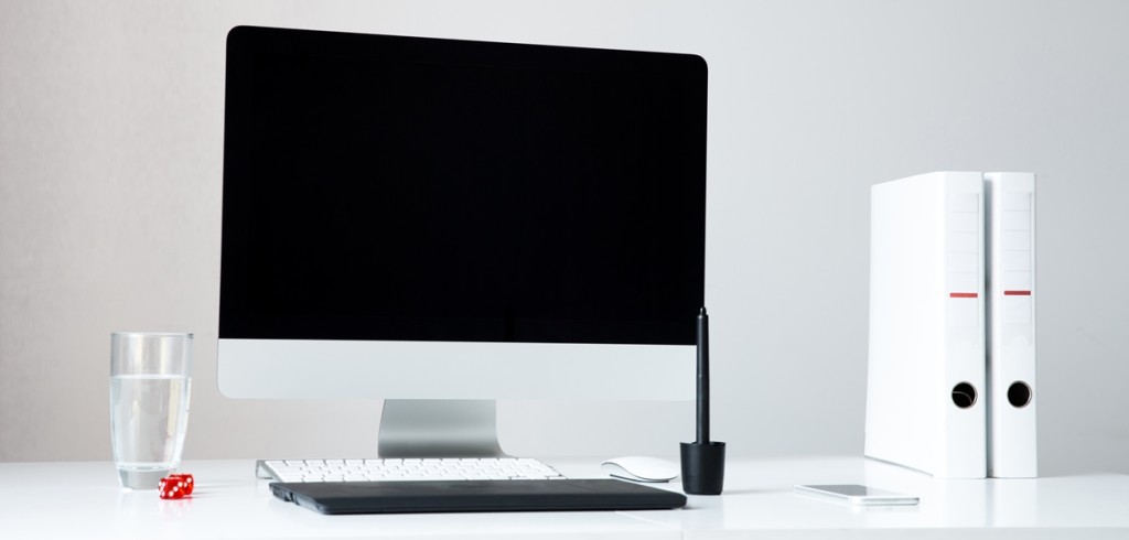 Closeup image of a computer on the table with blank screen in office